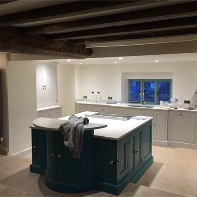 a large kitchen with a center island in the middle of the room