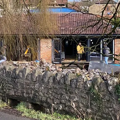 a group of people standing outside of a brick building