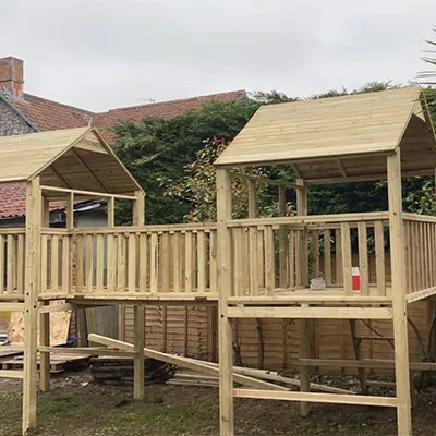 a wooden play set in a yard