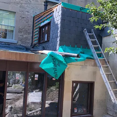 a ladder is attached to the roof of a building