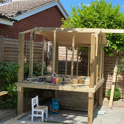 a wooden structure with a bench and a chair