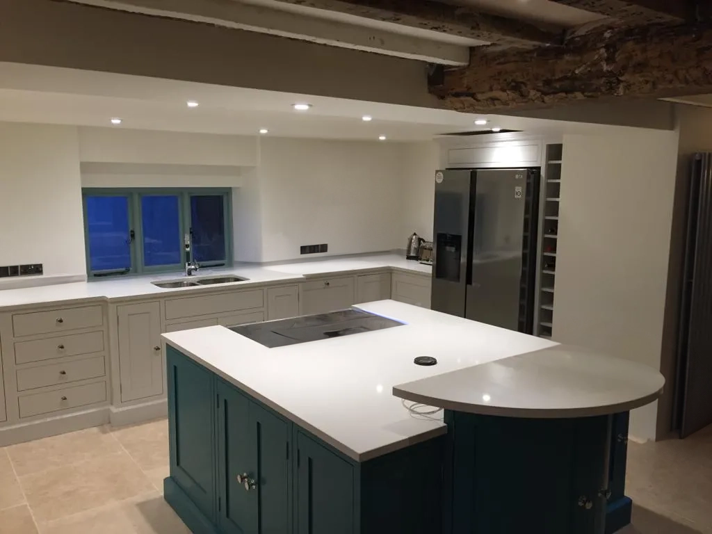 a large kitchen with a center island in the middle of the room