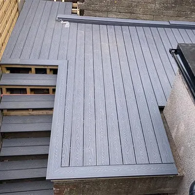 a cat sitting on top of a wooden deck