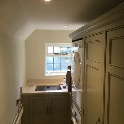 a kitchen with a sink and a washer and dryer