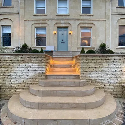 a stone building with steps leading up to the front door
